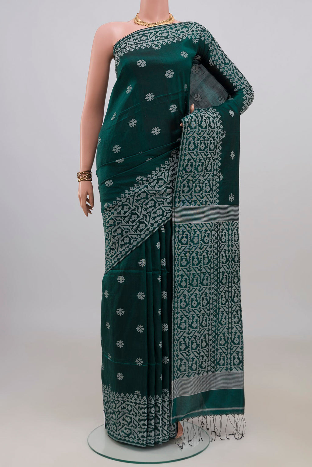Teal Tussar Saree with Thread Butta on the body and Fancy Border.  displayed on a mannequin