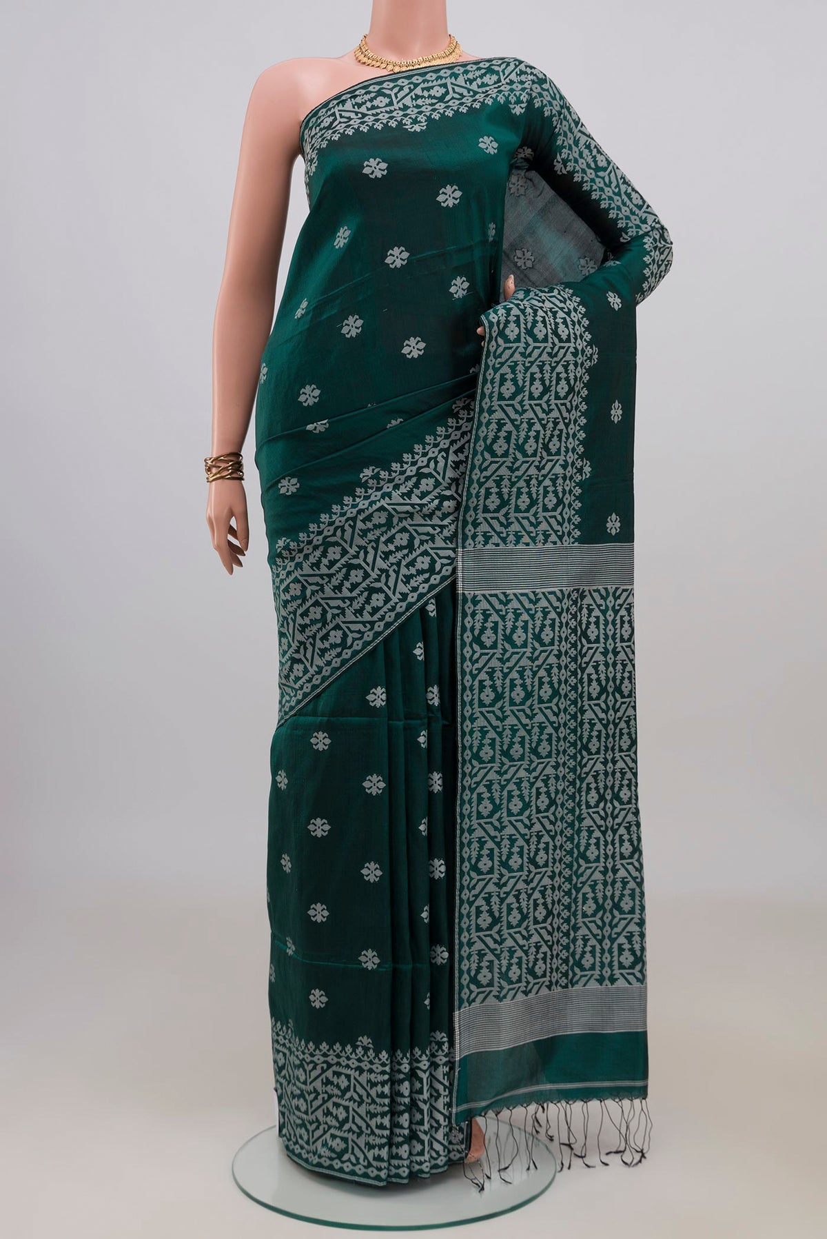 Teal Tussar Saree with Thread Butta on the body and Fancy Border.  displayed on a mannequin