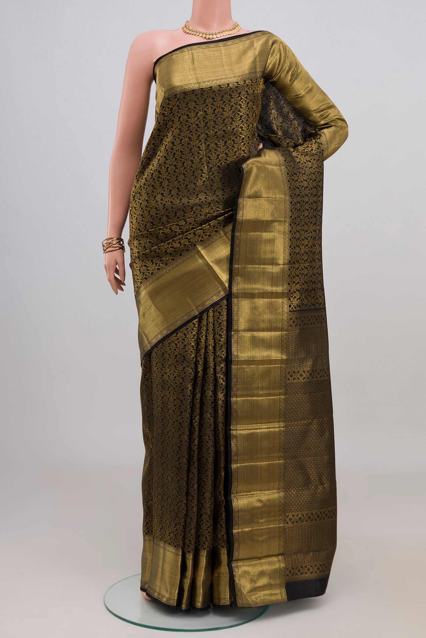 Black Kanchipuram Silk Saree with Zari Brocade on the body and Zari Border.  displayed on a mannequin