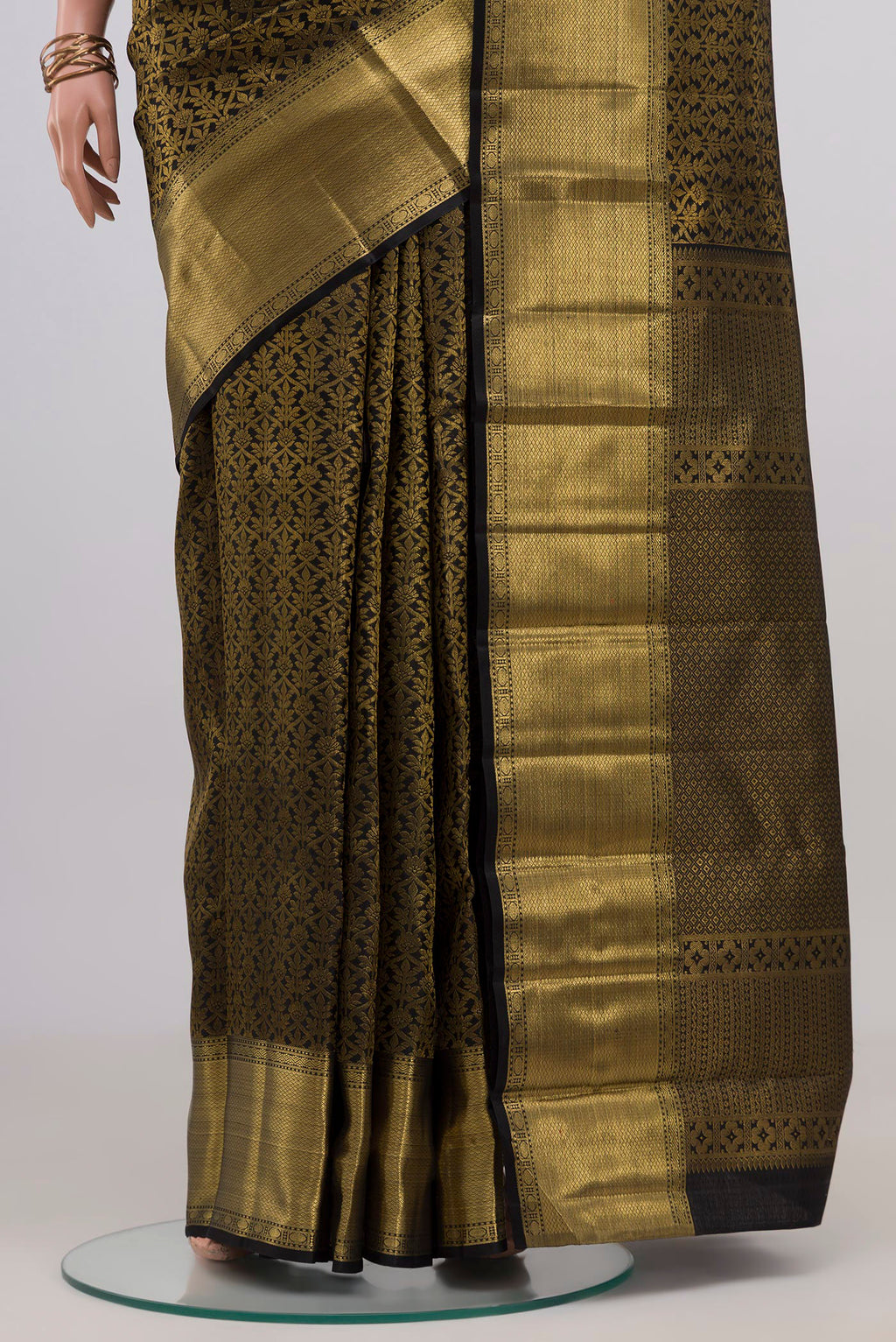Pleats and pallu of Black Kanchipuram Silk Saree with Zari Brocade on the body and Zari Border. 