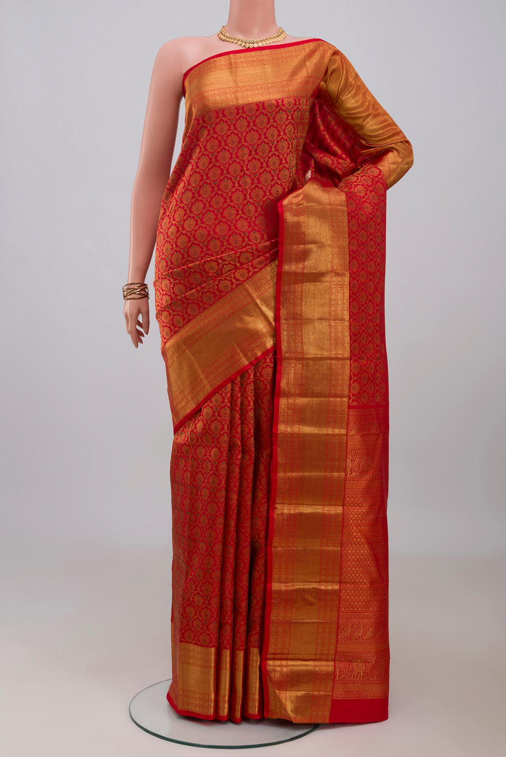 Red Kanchipuram Silk Saree with Zari Brocade on the body and Zari Border.  displayed on a mannequin