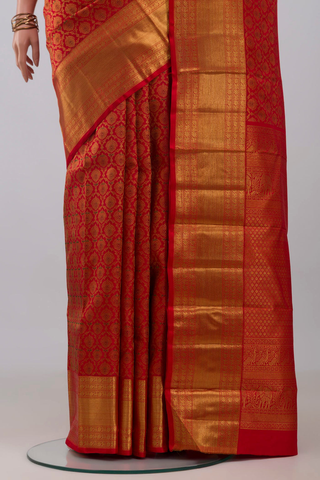 Pleats and pallu of Red Kanchipuram Silk Saree with Zari Brocade on the body and Zari Border. 