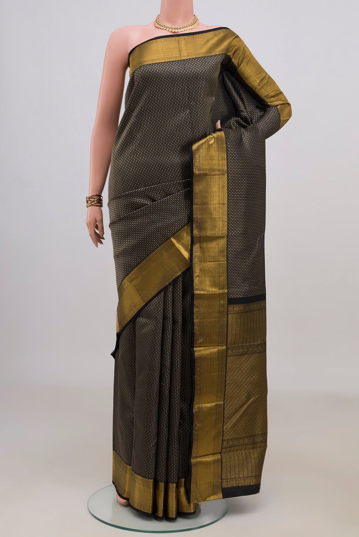 Pure Silk Black Kanchipuram Saree with Zari Brocade on the body and Zari Border.  displayed on a mannequin