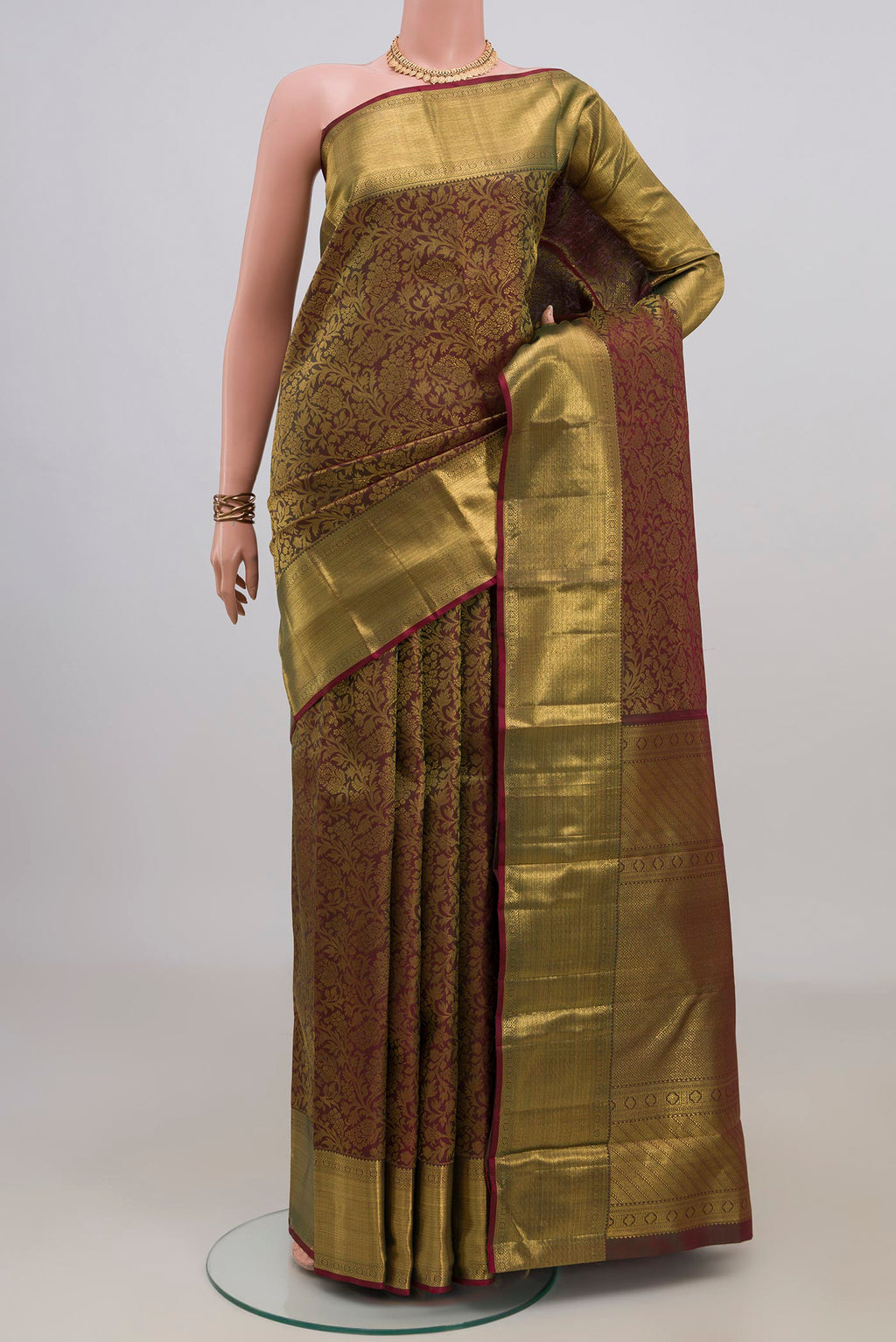 Pure Silk Green with Brown Color Kanchipuram Saree with Zari Brocade on the body and Zari Border.  displayed on a mannequin