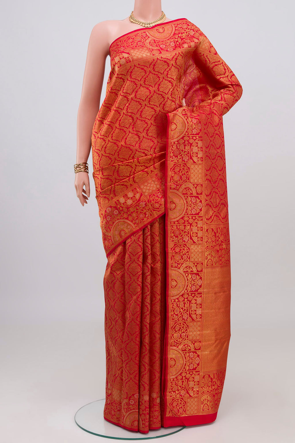 Red Kanjivaram Silk Saree with Zari Brocade on the body and Fancy Border.  displayed on a mannequin