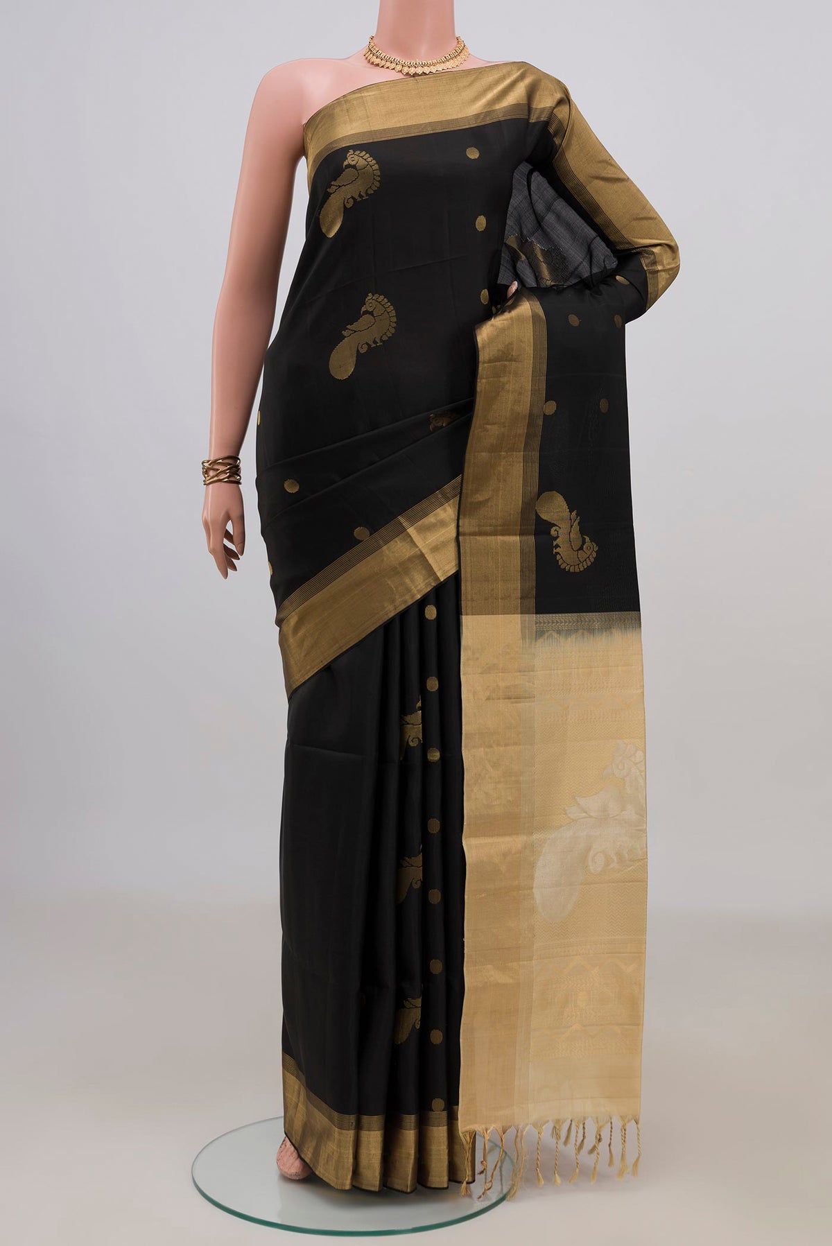 Pure Silk Black Soft Saree with Zari Butta on the body and Zari Border.  displayed on a mannequin