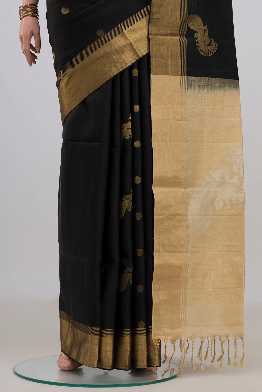Pleats and pallu of Pure Silk Black Soft Saree with Zari Butta on the body and Zari Border. 