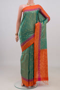 Pure Silk Turquoise Soft Saree with Zari Butta on the body and Fancy Border.  displayed on a mannequin
