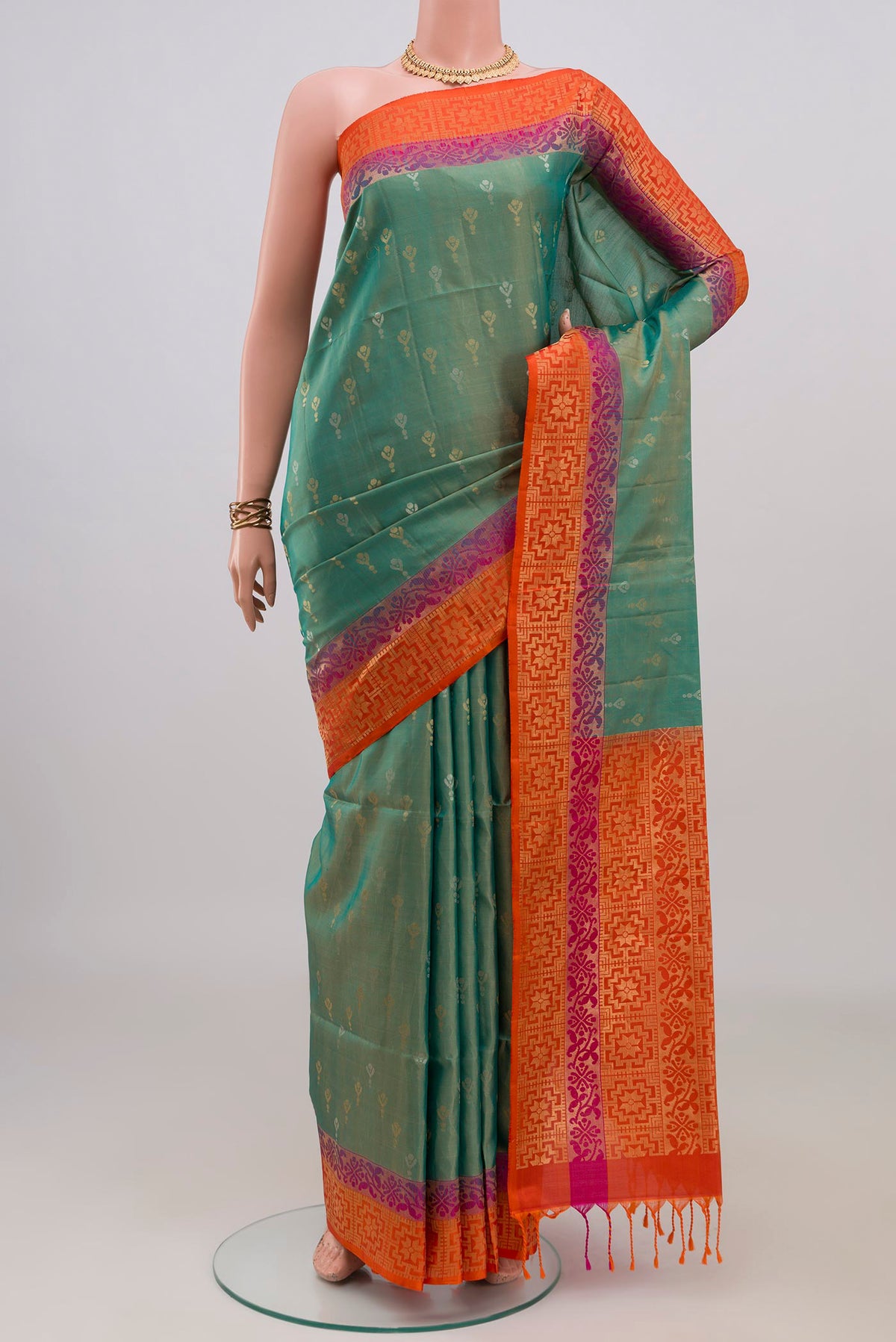 Pure Silk Turquoise Soft Saree with Zari Butta on the body and Fancy Border.  displayed on a mannequin