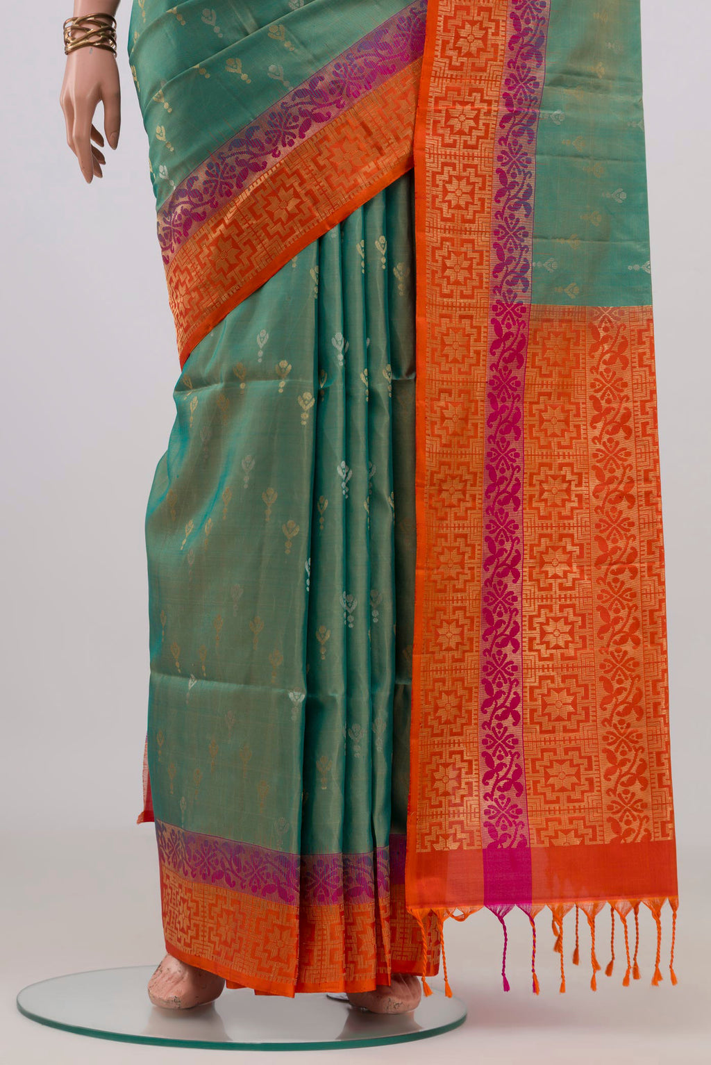 Pleats and pallu of Pure Silk Turquoise Soft Saree with Zari Butta on the body and Fancy Border. 