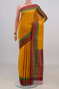 Pure Silk Mustard Soft Saree with Zari Butta on the body and Zari Border.  displayed on a mannequin