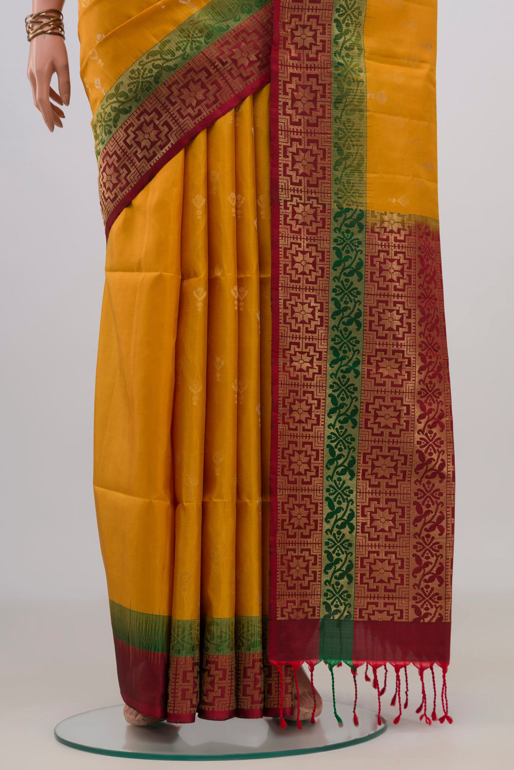 Pleats and pallu of Pure Silk Mustard Soft Saree with Zari Butta on the body and Zari Border. 