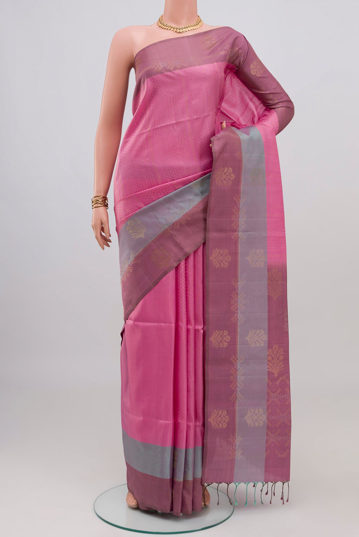 Rose pink Soft Silk Saree with Zari Butta on the body and Fancy Border.  displayed on a mannequin