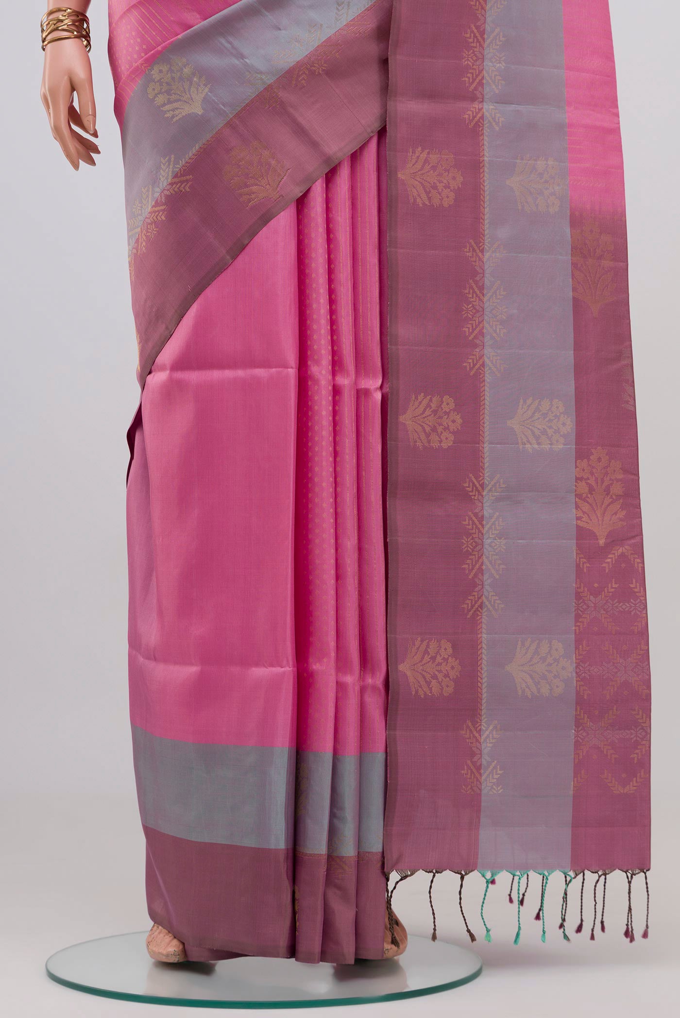 Pleats and pallu of Rose pink Soft Silk Saree with Zari Butta on the body and Fancy Border. 