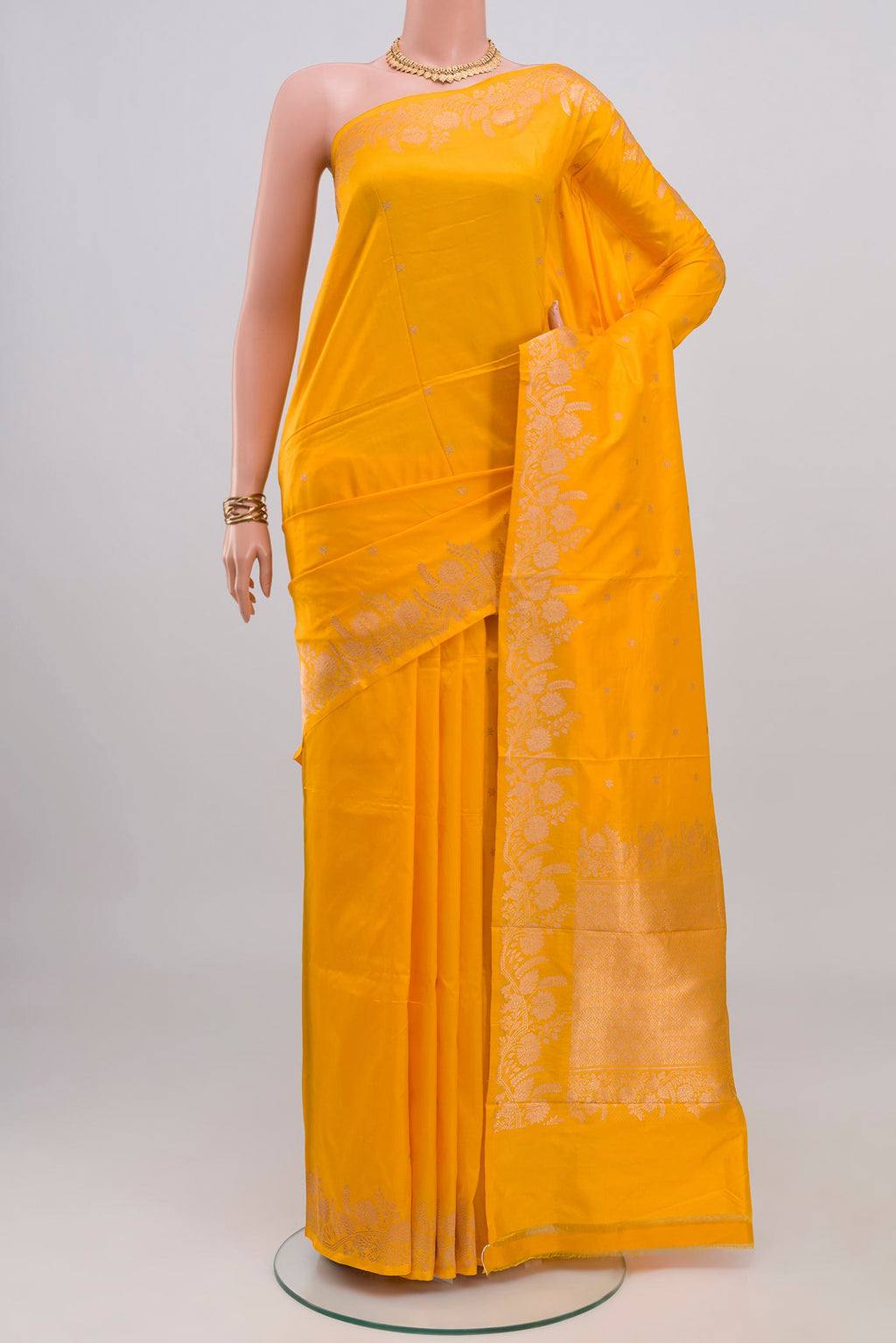 Yellow Banarasi Katan Silk Saree with Zari Butta on the body and Fancy Border.  displayed on a mannequin