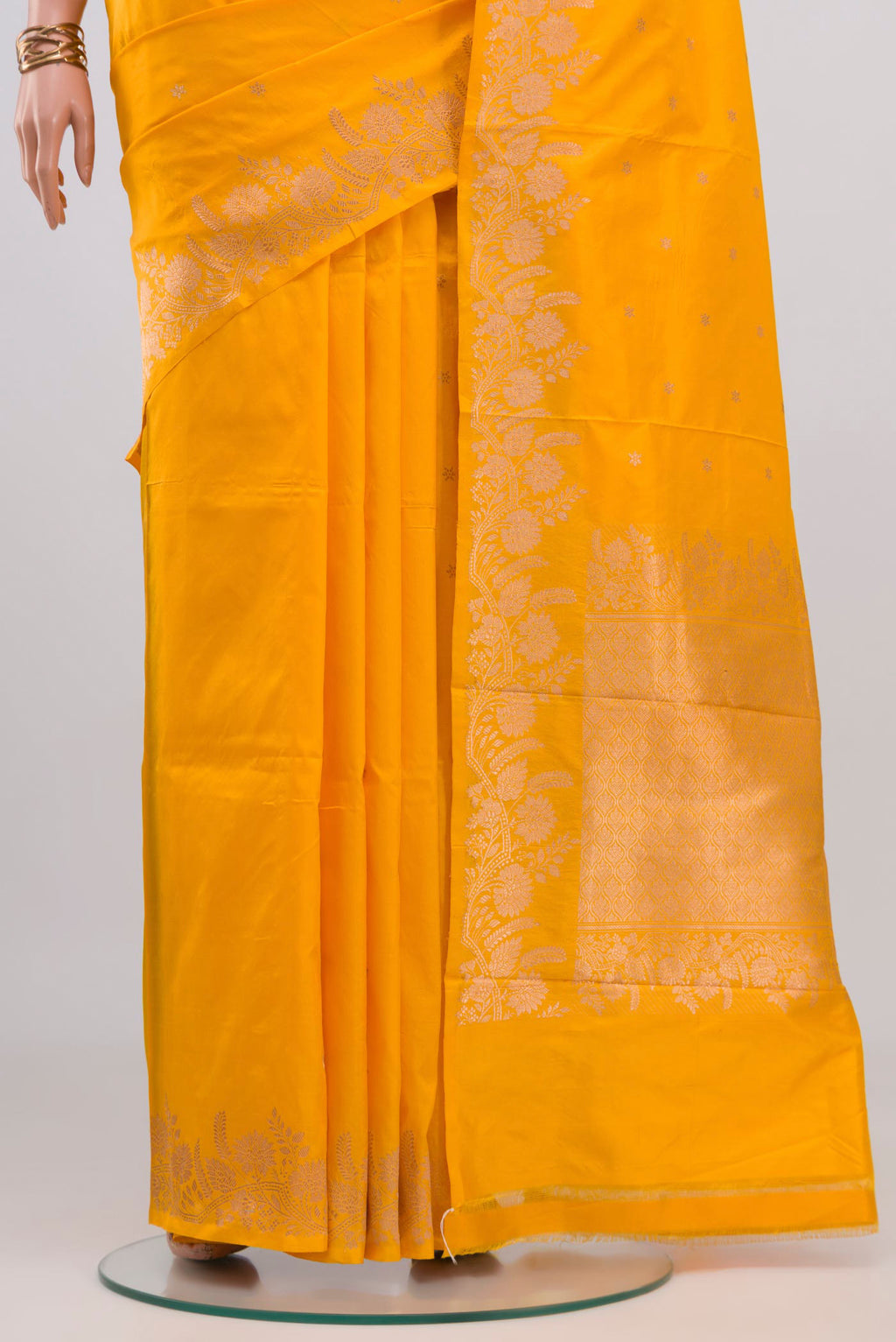 Pleats and pallu of Yellow Banarasi Katan Silk Saree with Zari Butta on the body and Fancy Border. 
