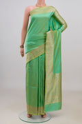 Pure Silk Green Banarasi Katan Saree with Zari Butta on the body and Zari Border.  displayed on a mannequin