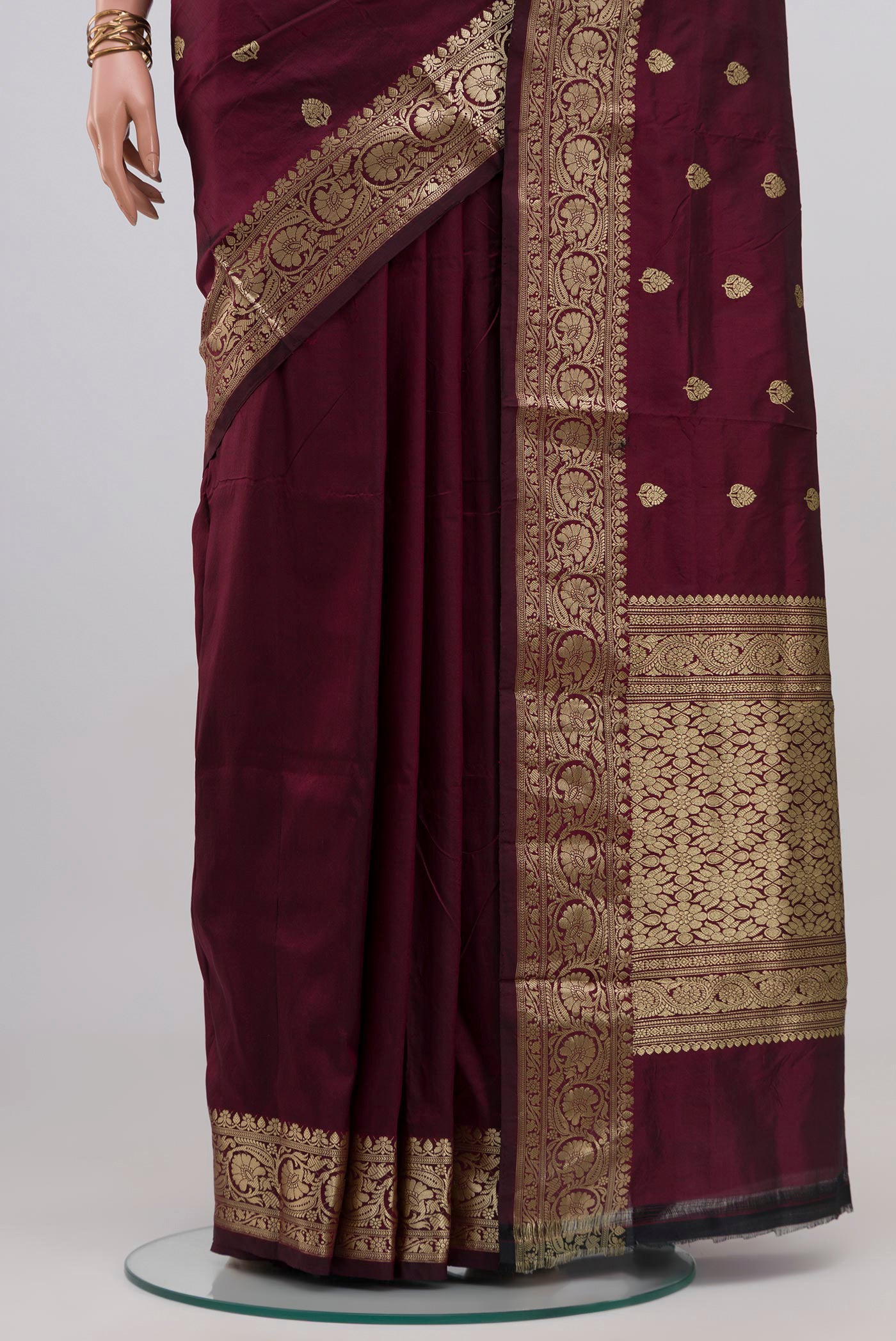 Pleats and pallu of Maroon Banarasi Katan Silk Saree with Zari Butta on the body and Zari Border. 