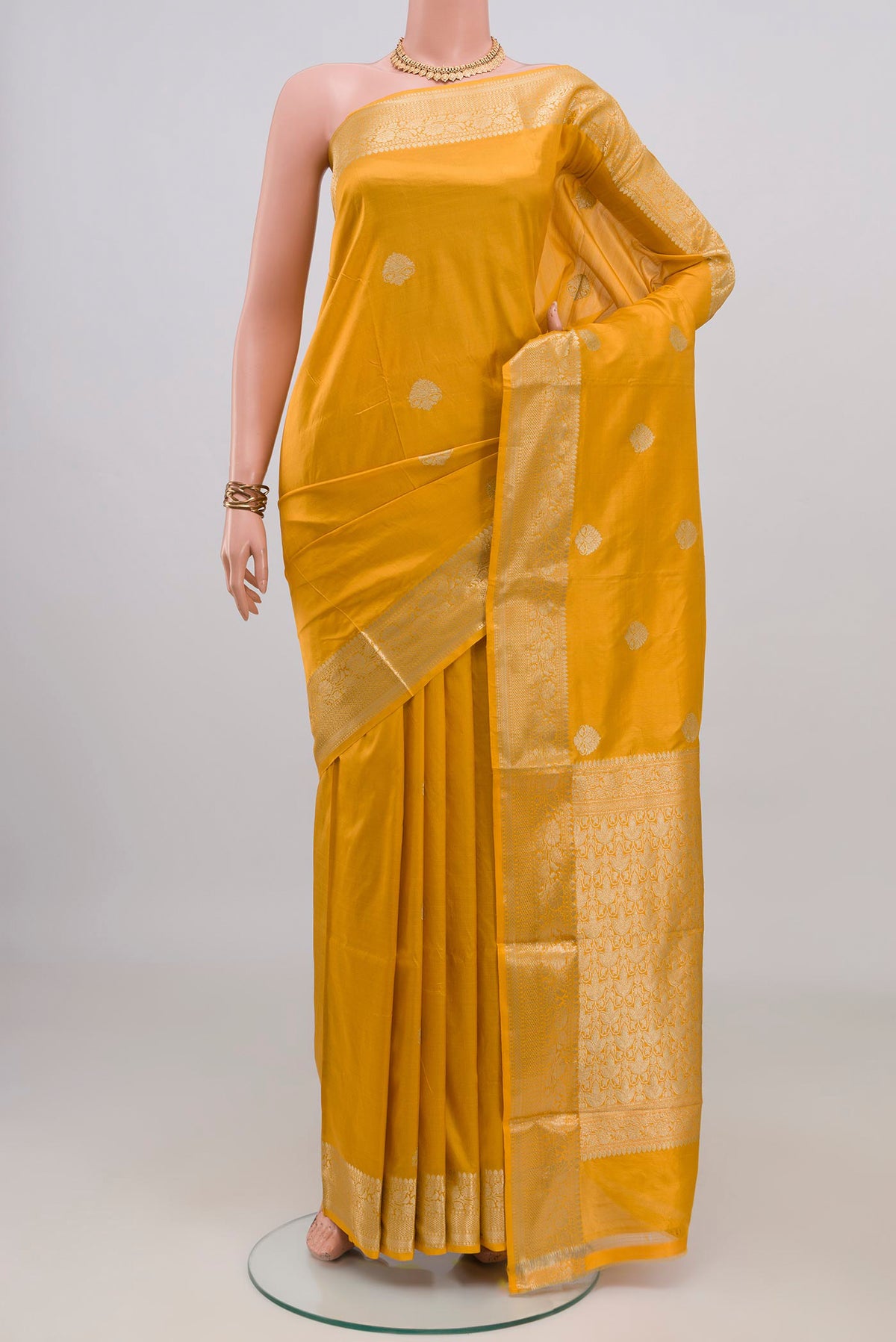 Pure Silk Yellow Banarasi Katan Saree with Zari Butta on the body and Zari Border.  displayed on a mannequin