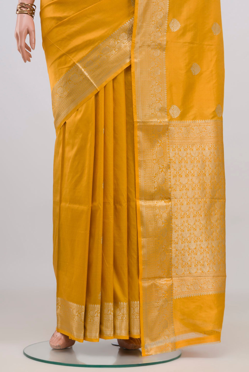 Pleats and pallu of Pure Silk Yellow Banarasi Katan Saree with Zari Butta on the body and Zari Border. 
