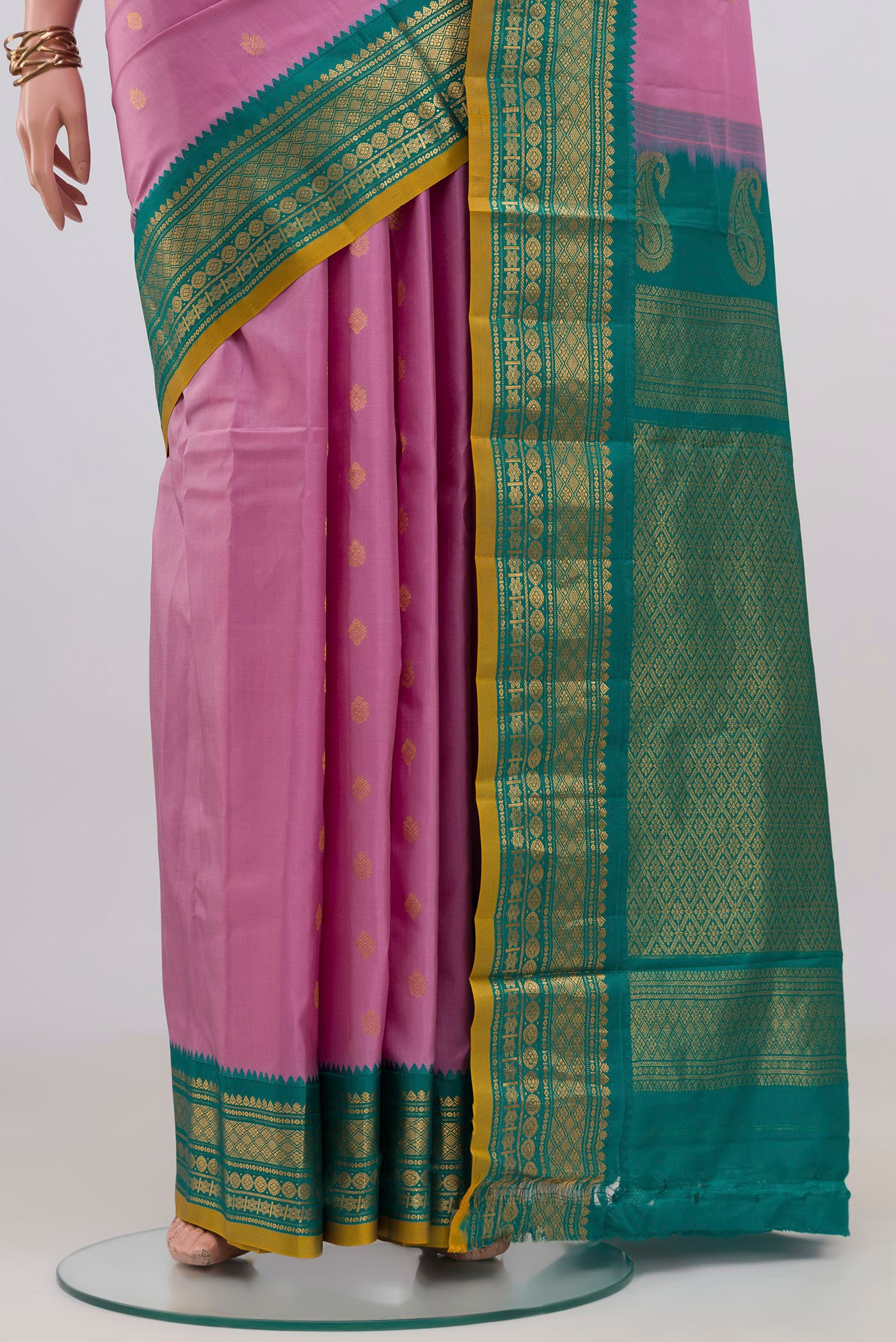 Pleats and pallu of Pink Gadwal Silk Saree with Zari Butta on the body and Zari Border. 