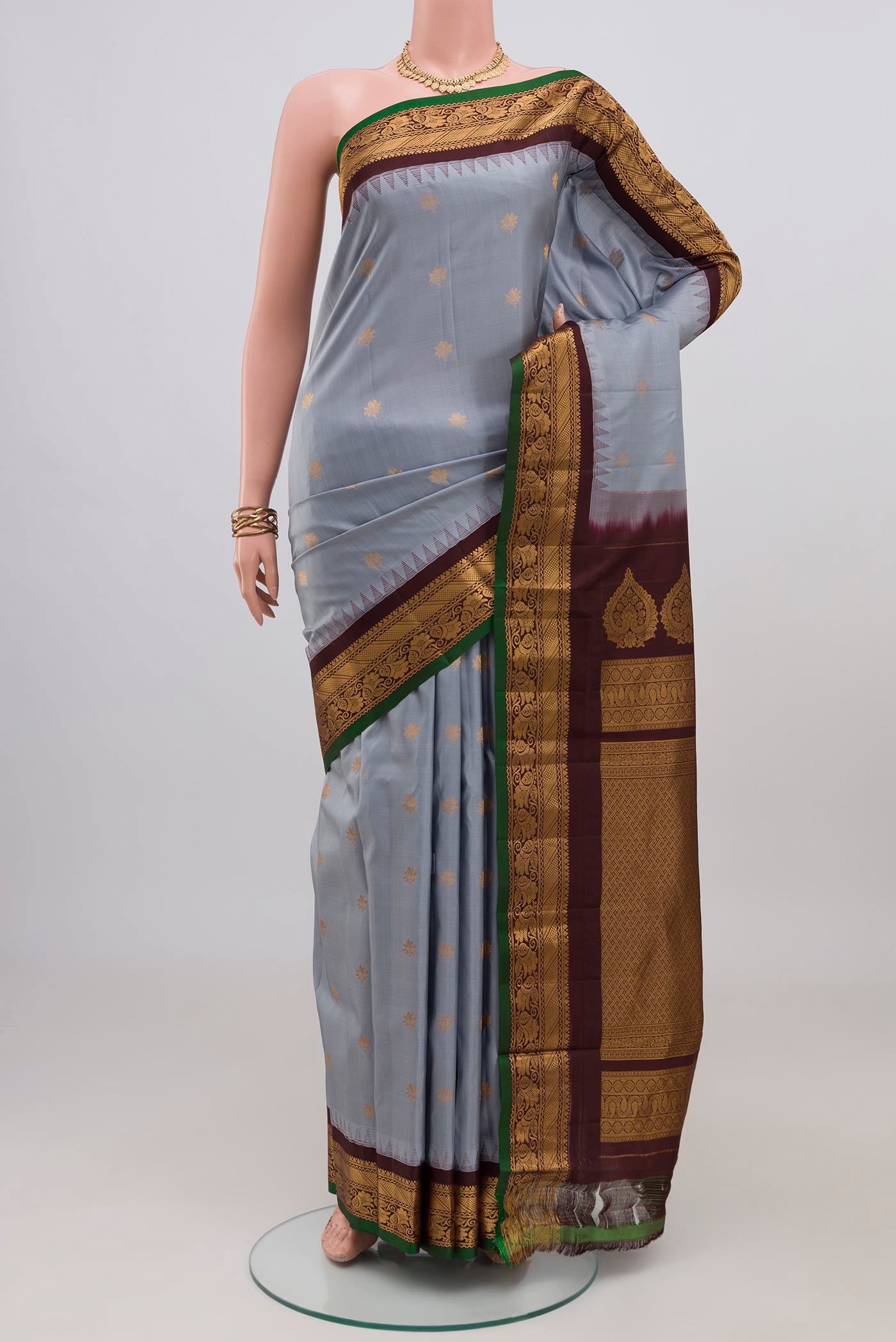 Blue Grey Gadwal Silk Saree with Zari Butta on the body and Zari Border.  displayed on a mannequin