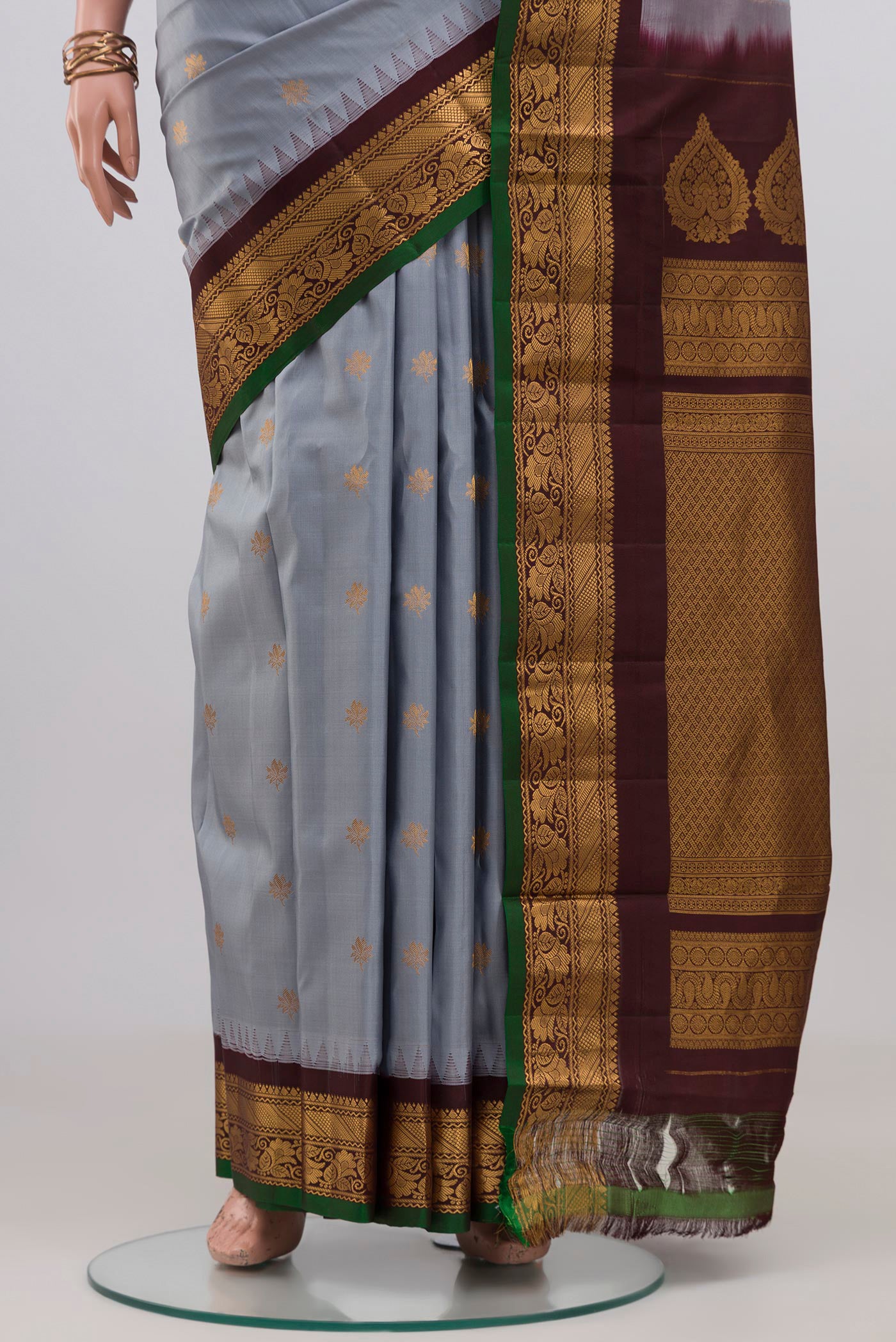 Pleats and pallu of Blue Grey Gadwal Silk Saree with Zari Butta on the body and Zari Border. 