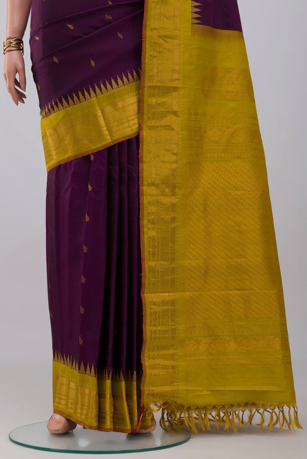 Pleats and pallu of Purple Gadwal Silk Saree with Zari Butta on the body and Zari Border. 