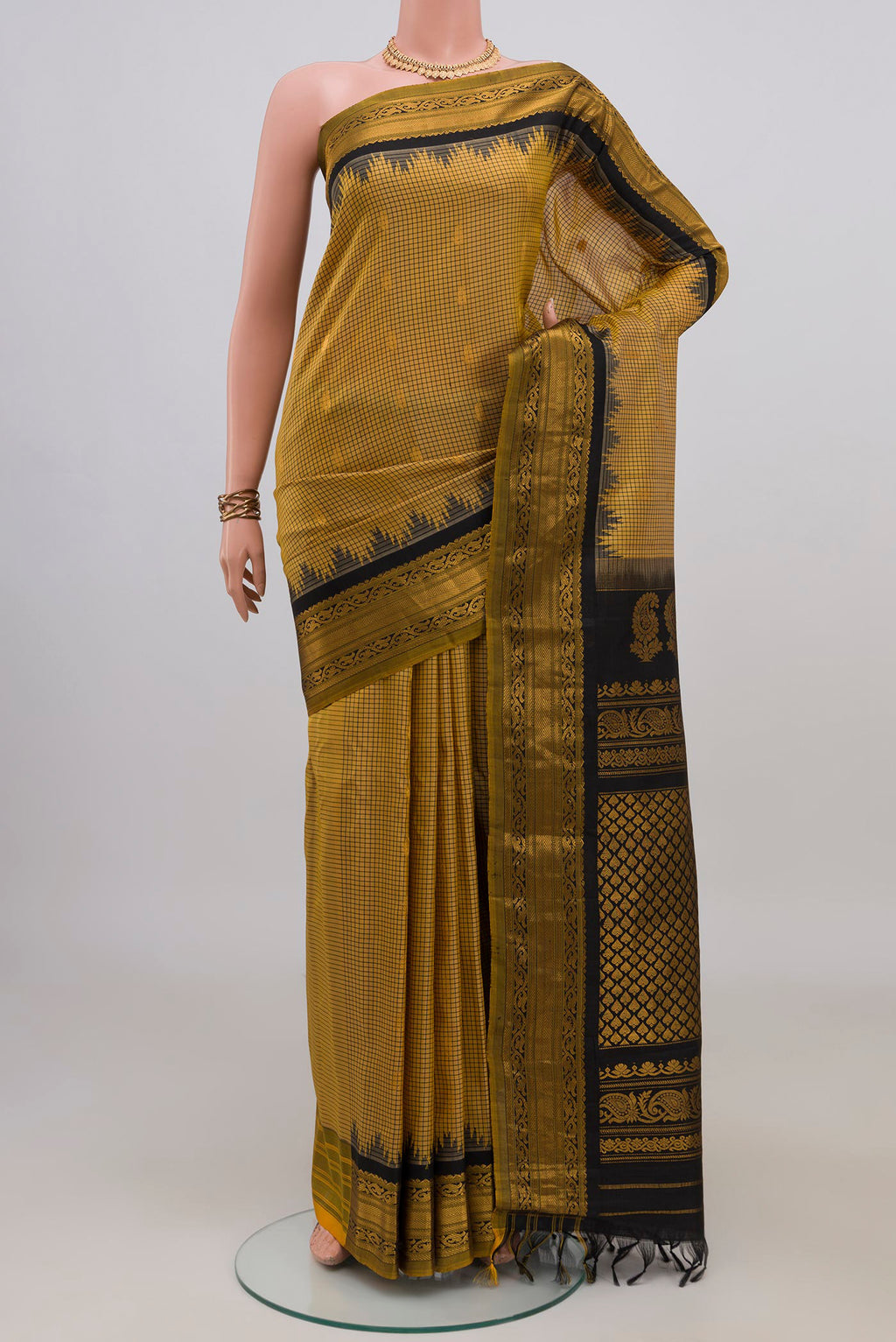 Pure Silk Yellow Gadwal Saree with Checked design on the body and Zari Border.  displayed on a mannequin