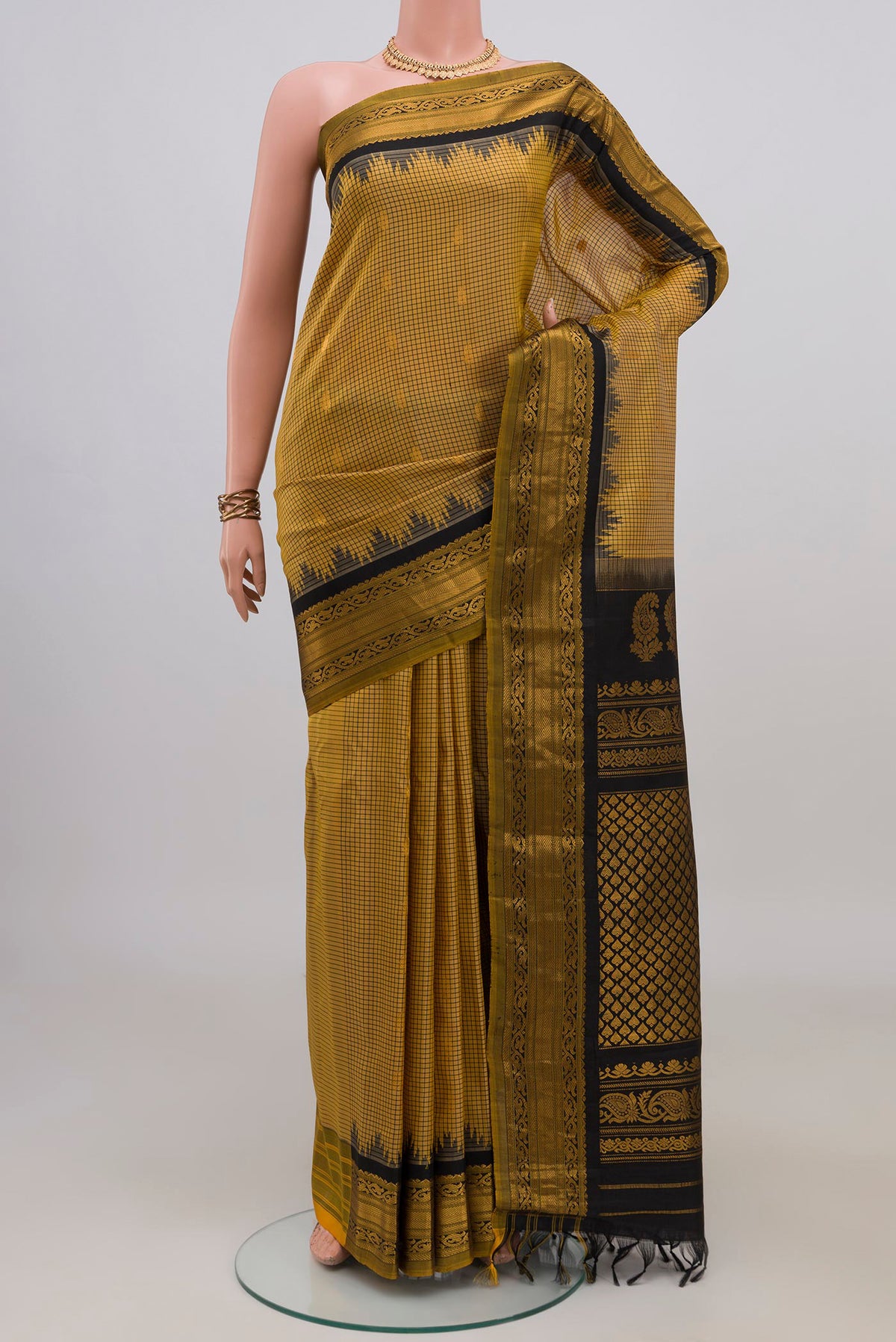 Pure Silk Yellow Gadwal Saree with Checked design on the body and Zari Border.  displayed on a mannequin