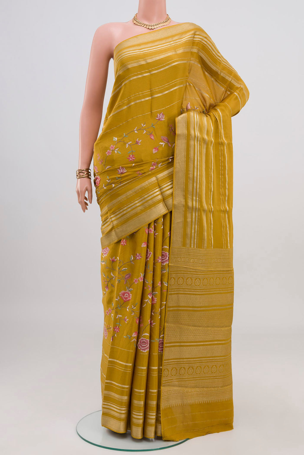 Yellow Crepe Saree with Fancy on the body and Fancy Border.  displayed on a mannequin