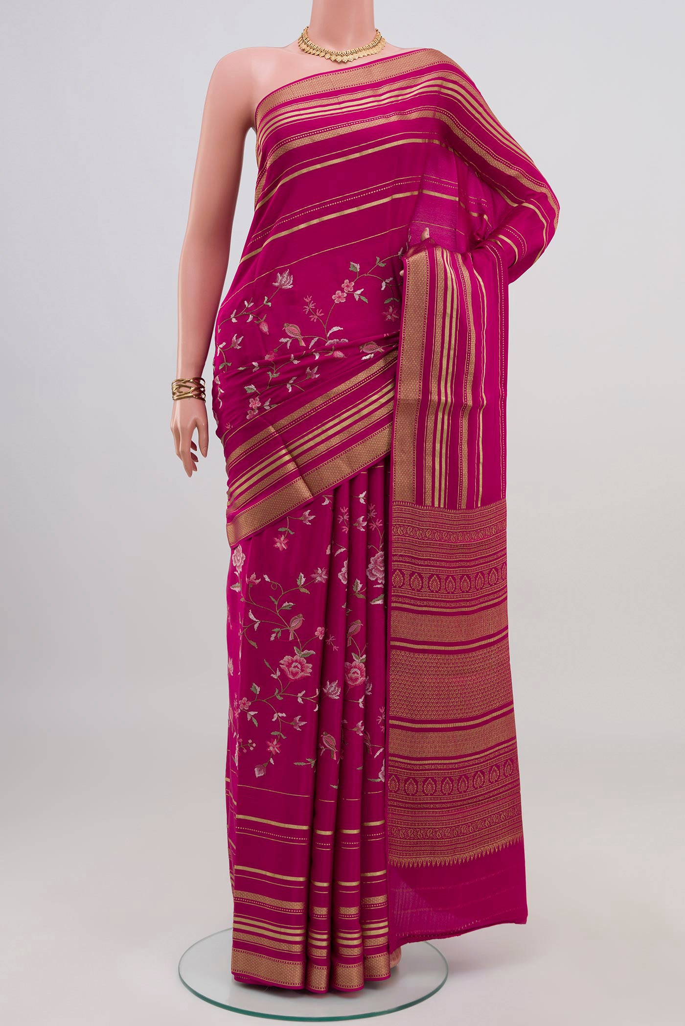 Pink Crepe Saree with Fancy on the body and Fancy Border.  displayed on a mannequin