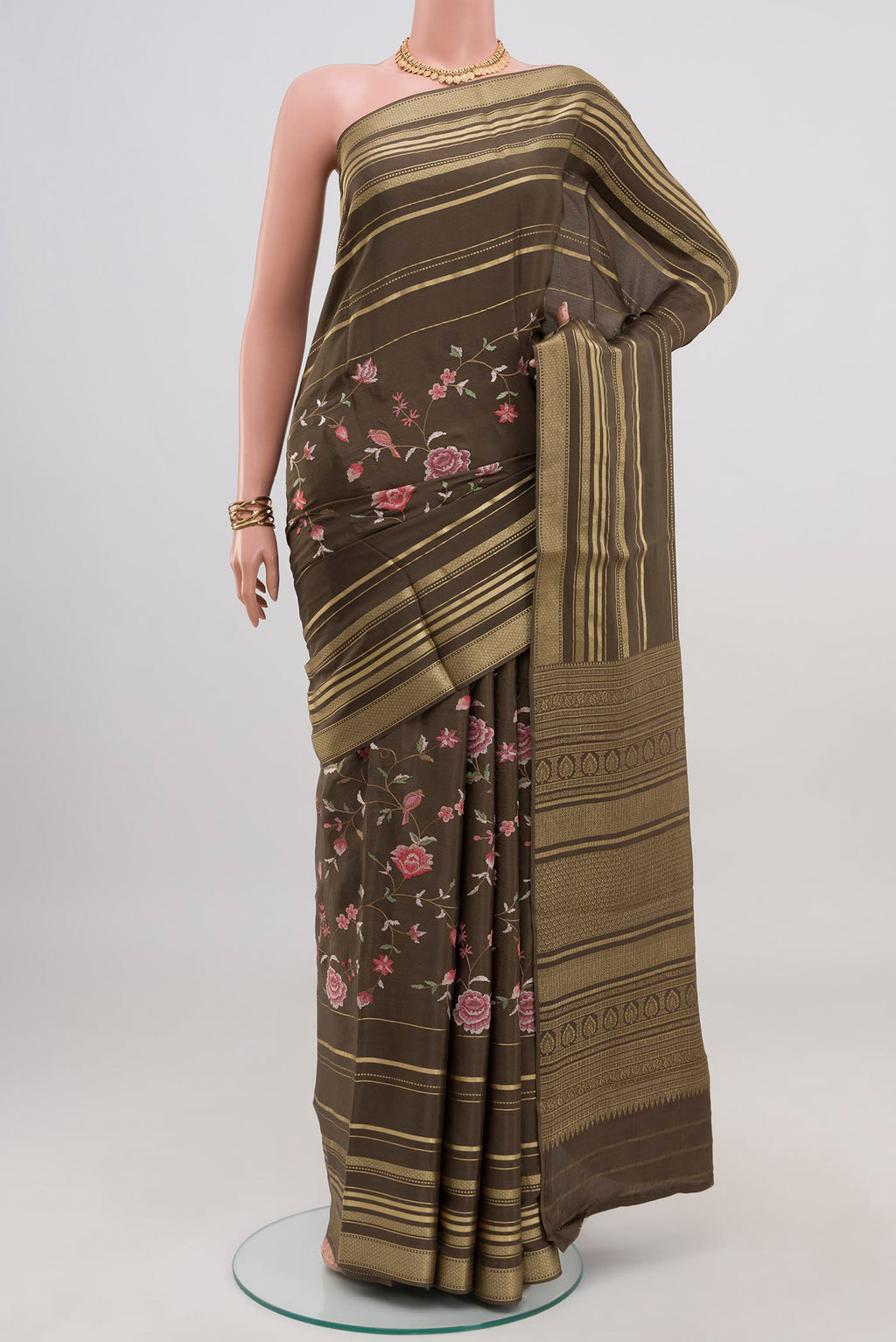 Mehandi Green Crepe Saree with Fancy on the body and Fancy Border.  displayed on a mannequin