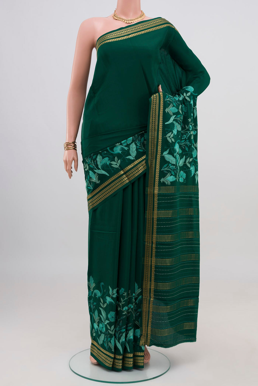 Green Crepe Saree with Fancy on the body and Fancy Border.  displayed on a mannequin