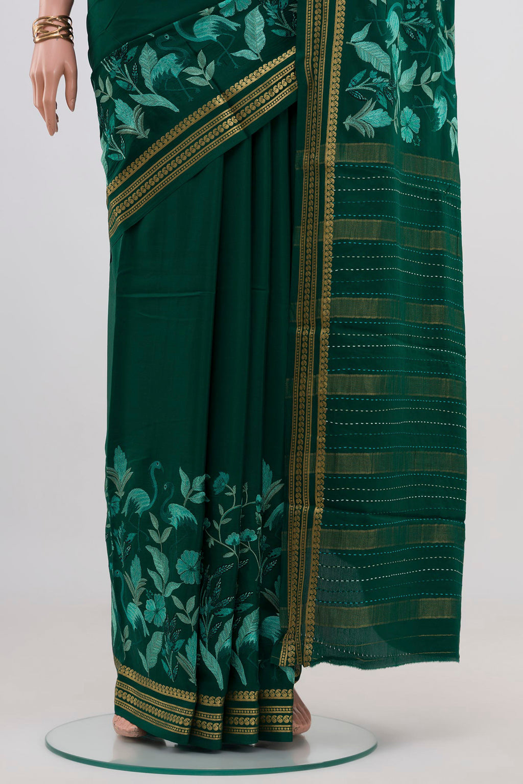 Pleats and pallu of Green Crepe Saree with Fancy on the body and Fancy Border. 