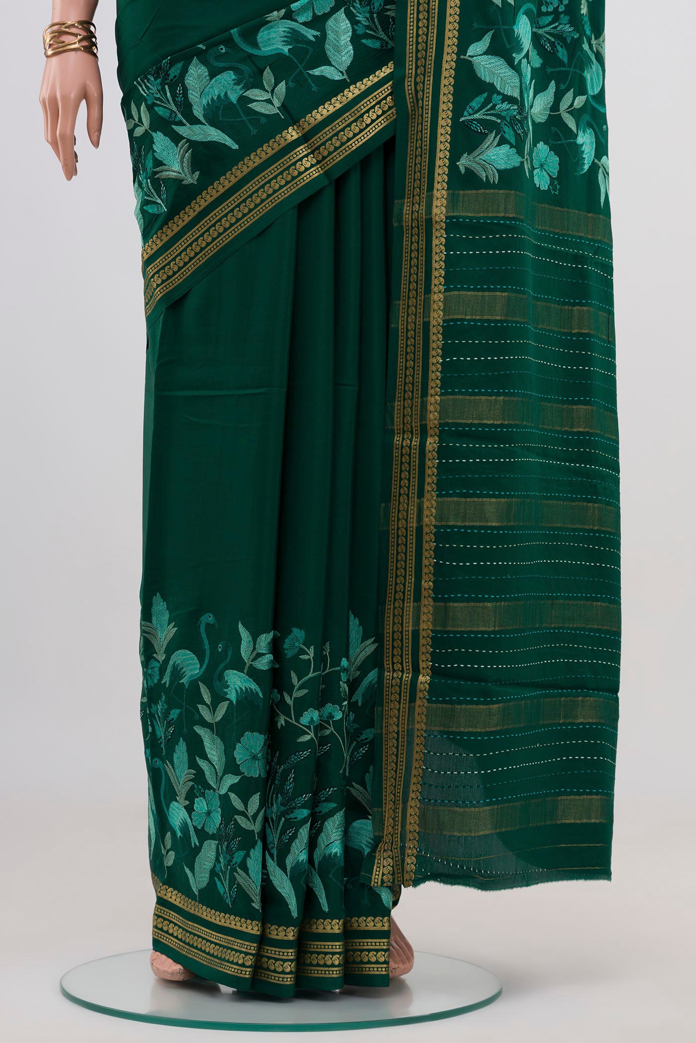 Pleats and pallu of Green Crepe Saree with Fancy on the body and Fancy Border. 