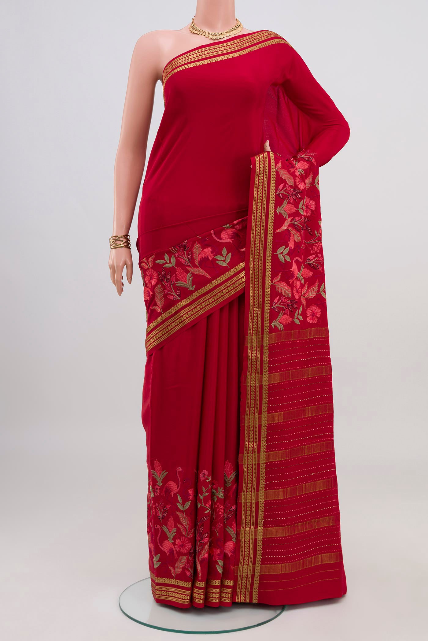 Red Crepe Saree with Fancy on the body and Fancy Border.  displayed on a mannequin