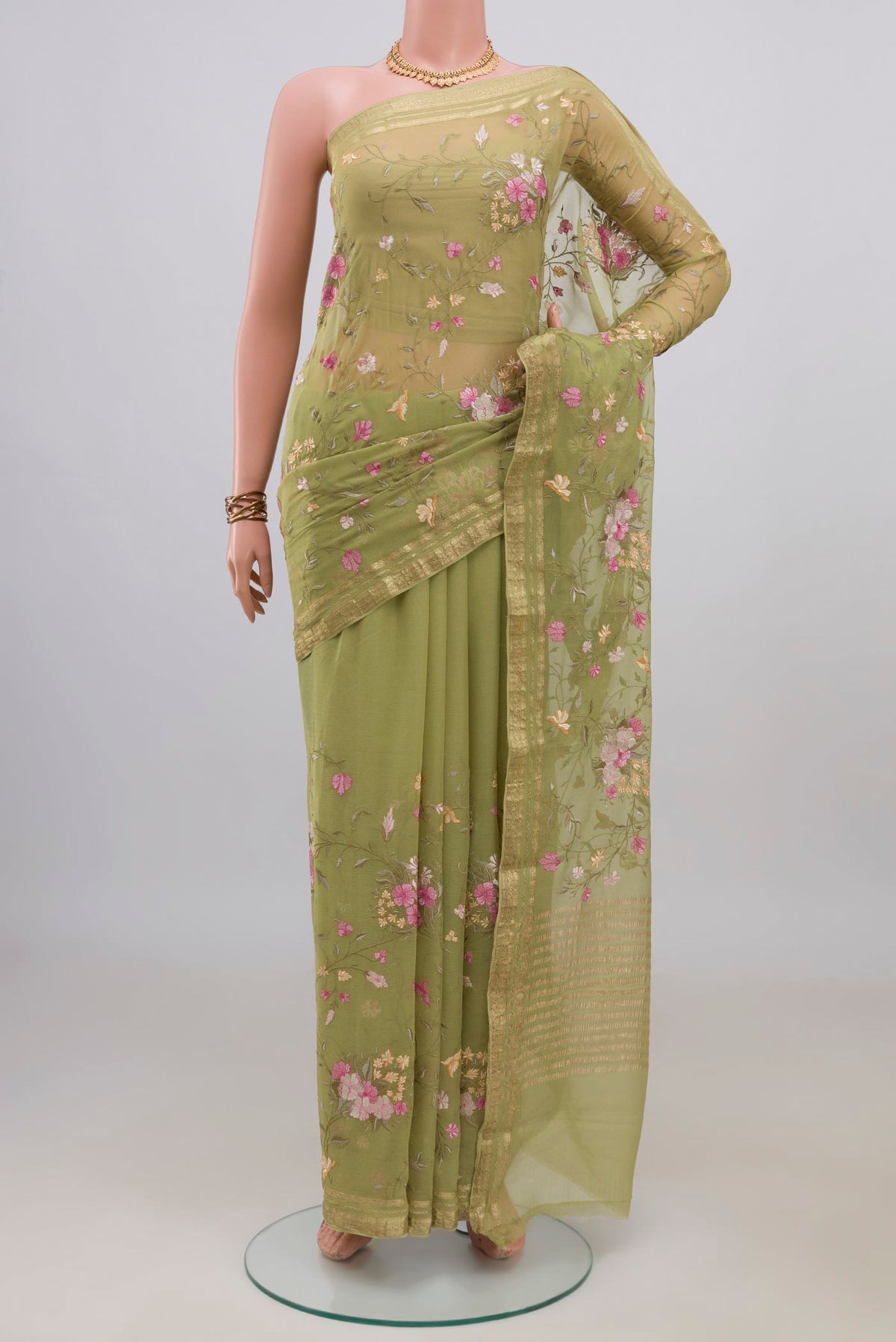 Green Mysore Chiffon Saree with Embroidery on the body and Zari Border.  displayed on a mannequin