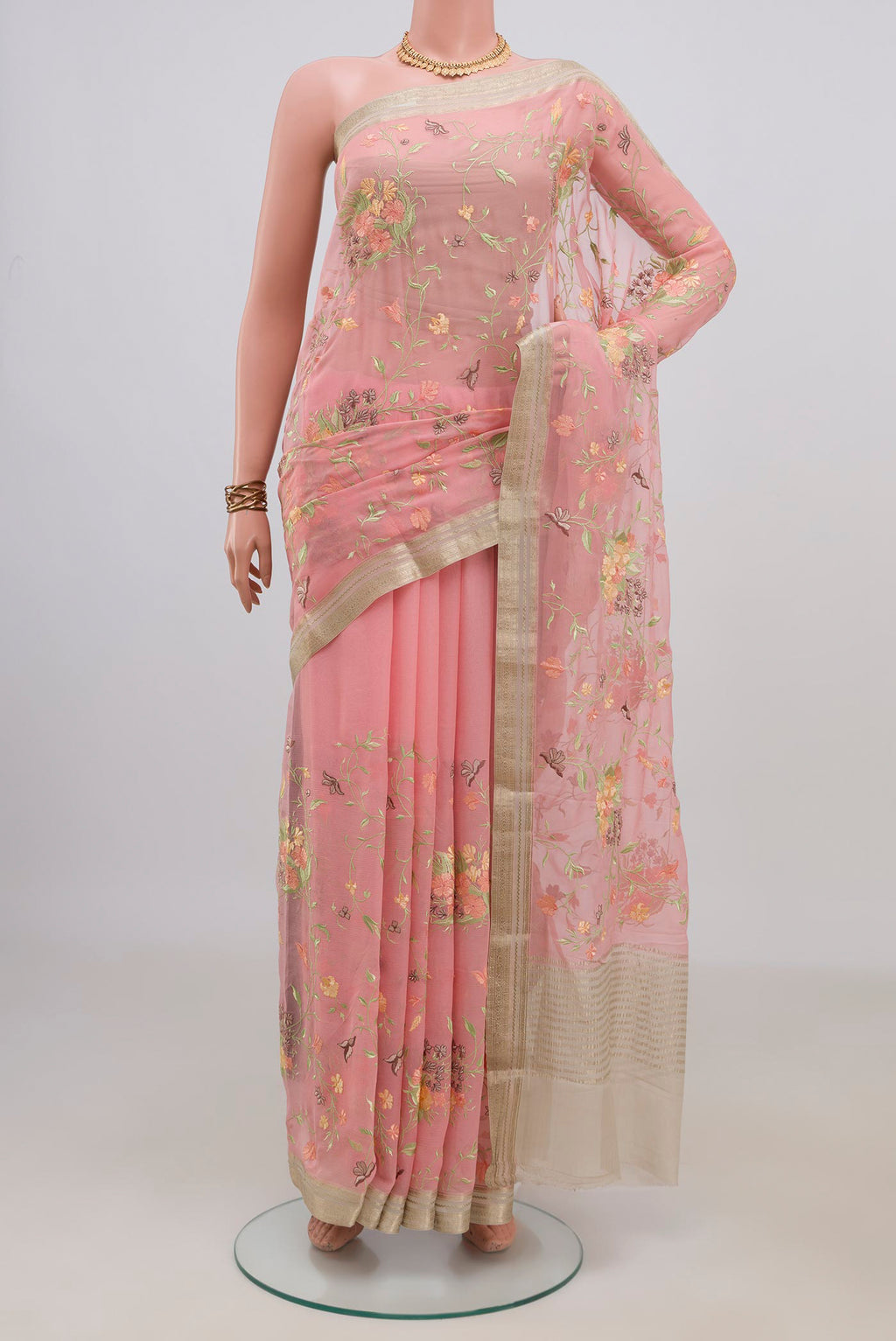 Peach Mysore Chiffon Saree with Embroidery on the body and Zari Border.  displayed on a mannequin
