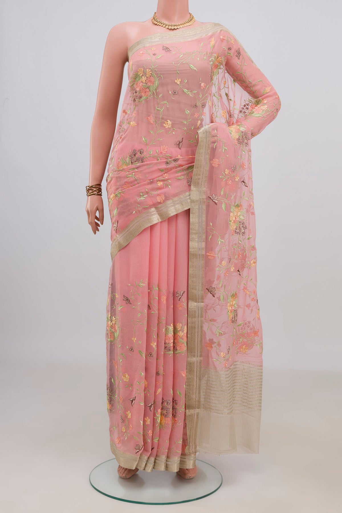 Peach Mysore Chiffon Saree with Embroidery on the body and Zari Border.  displayed on a mannequin