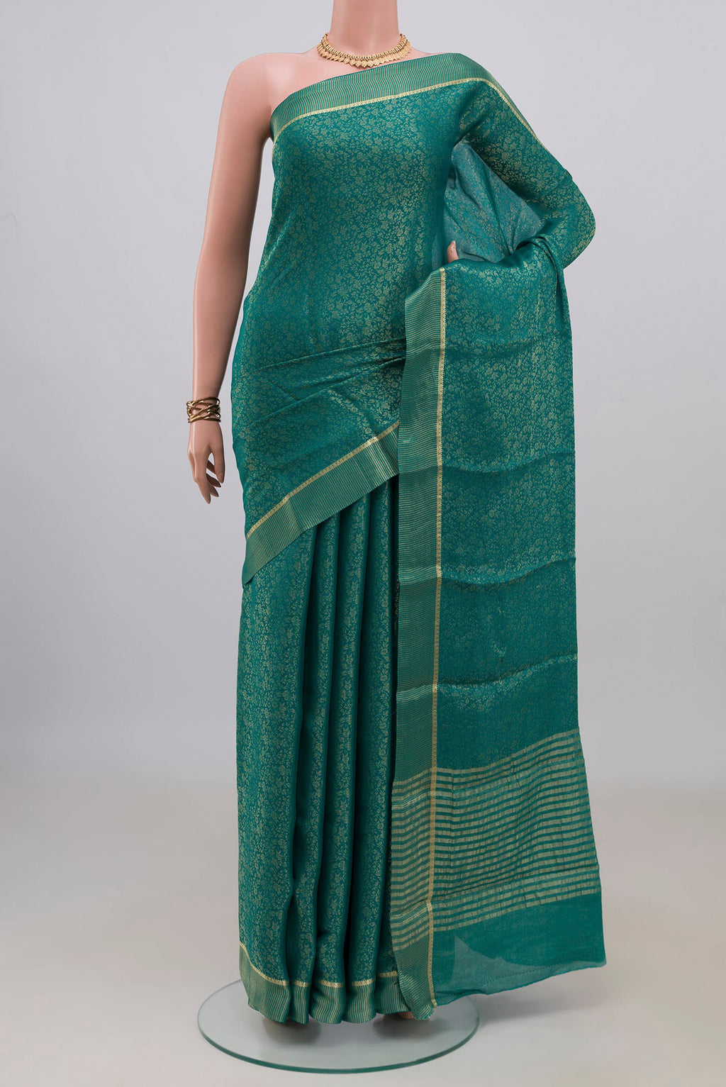Sea Green Mysore Crepe Saree with Zari Brocade on the body and Thin Zari Line.  displayed on a mannequin