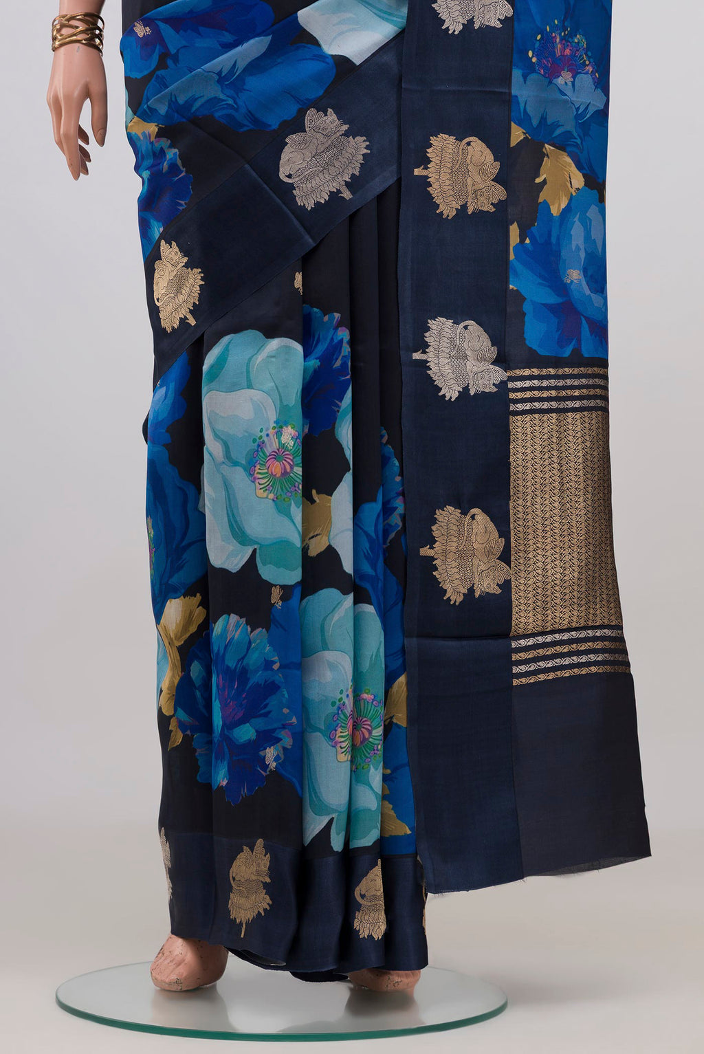 Pleats and pallu of Navy Blue Banarasi Katan Silk Saree with Floral Print on the body and Fancy Border. 