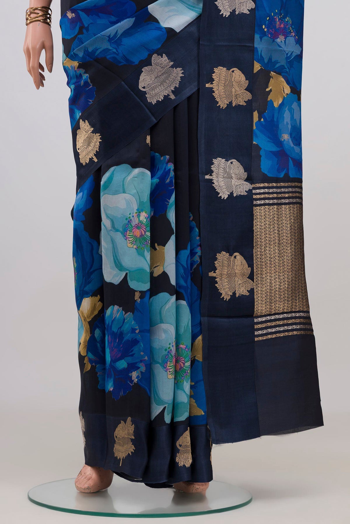 Pleats and pallu of Navy Blue Banarasi Katan Silk Saree with Floral Print on the body and Fancy Border. 