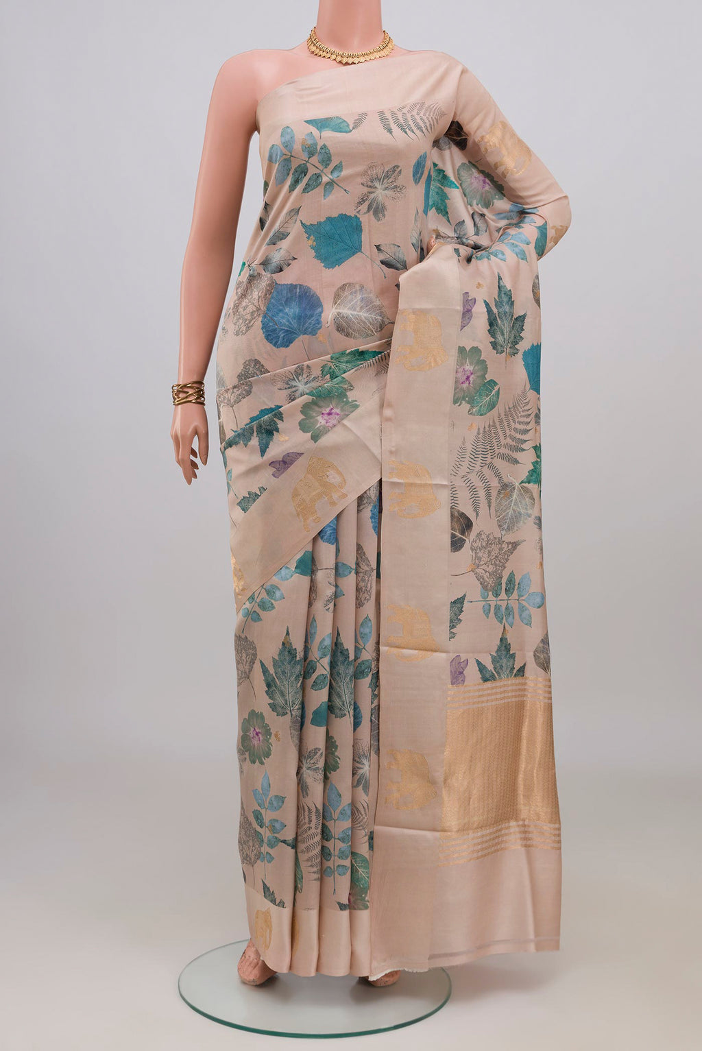 Cream Banarasi Katan Silk Saree with Floral Print on the body and Fancy Border.  displayed on a mannequin