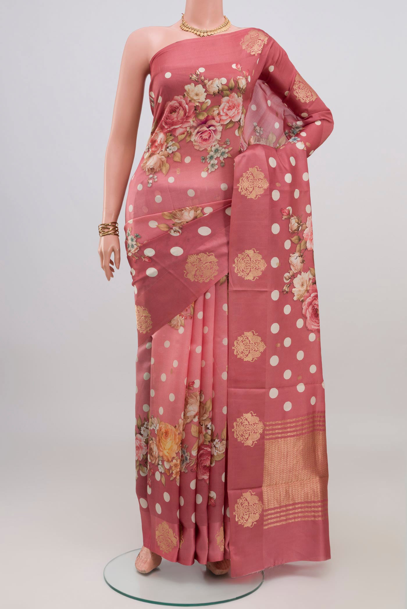 Pink Tussar Silk Saree with Printed design on the body and Fancy Border.  displayed on a mannequin
