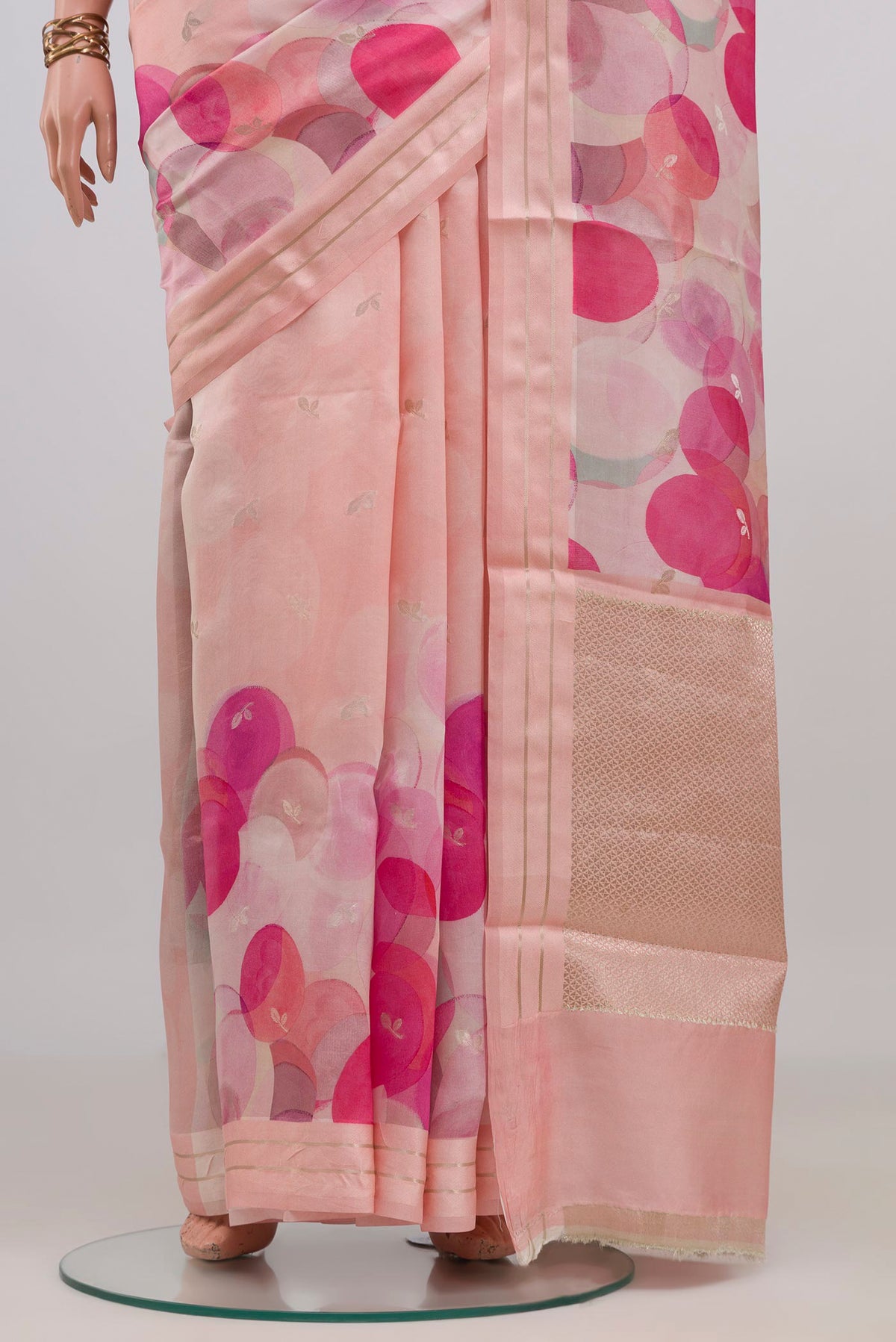 Pleats and pallu of Rose pink Banarasi Katan Silk Saree with Floral Print on the body and Thin Zari Line. 