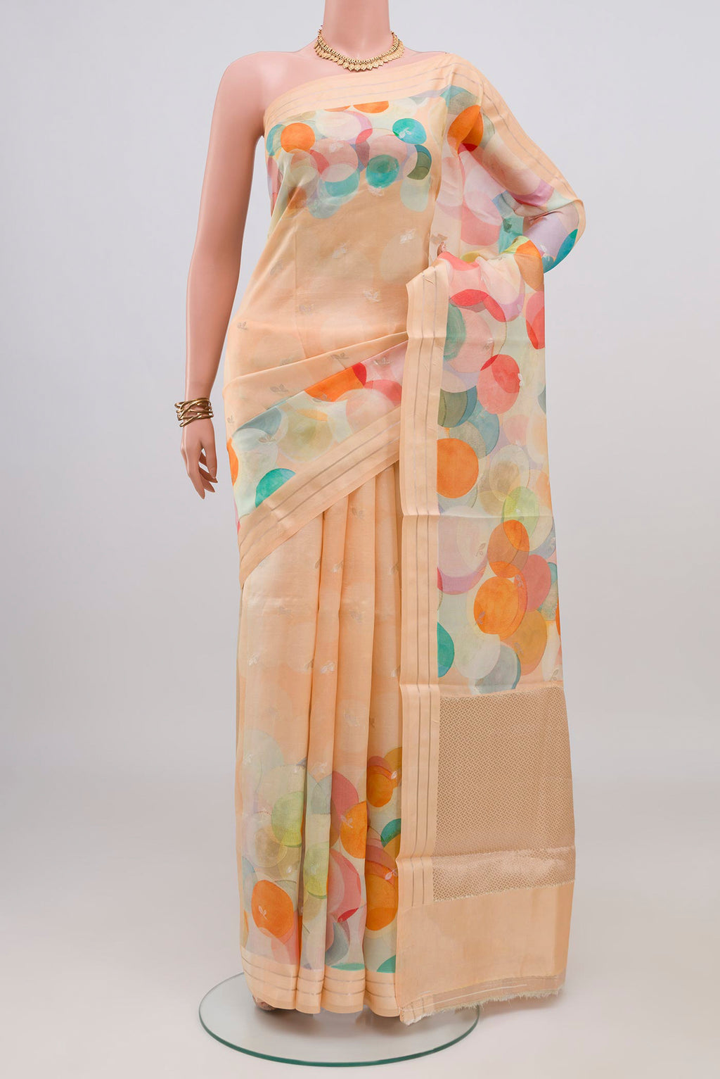 Peach Banarasi Katan Silk Saree with Printed design on the body and Satin Border.  displayed on a mannequin