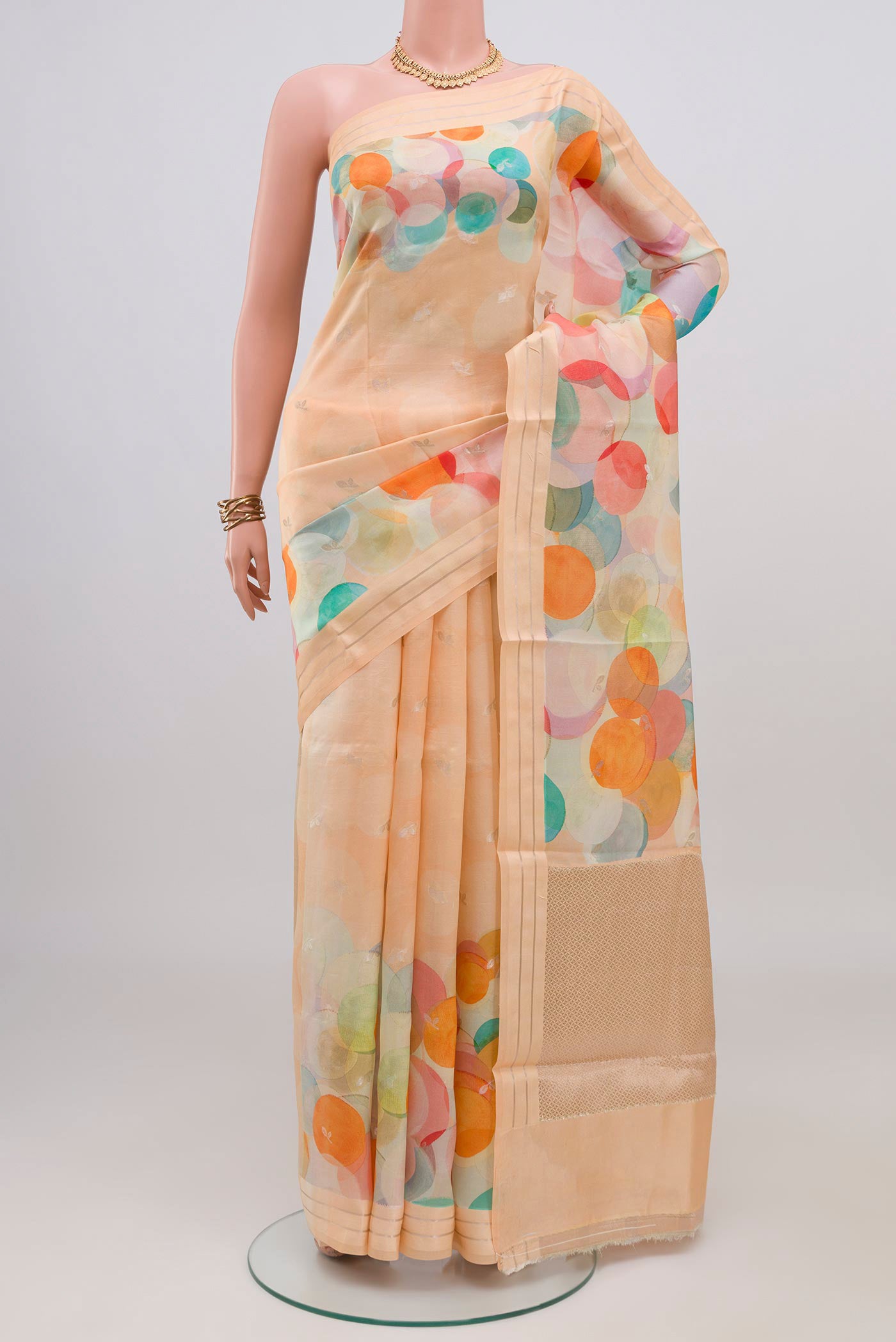Peach Banarasi Katan Silk Saree with Printed design on the body and Satin Border.  displayed on a mannequin