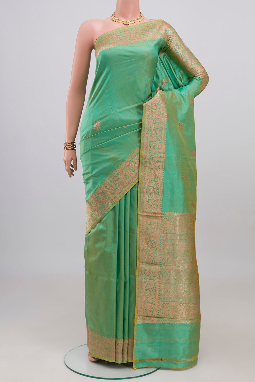 Sea Green Banarasi Katan Silk Saree with Zari Butta on the body and Zari Border.  displayed on a mannequin