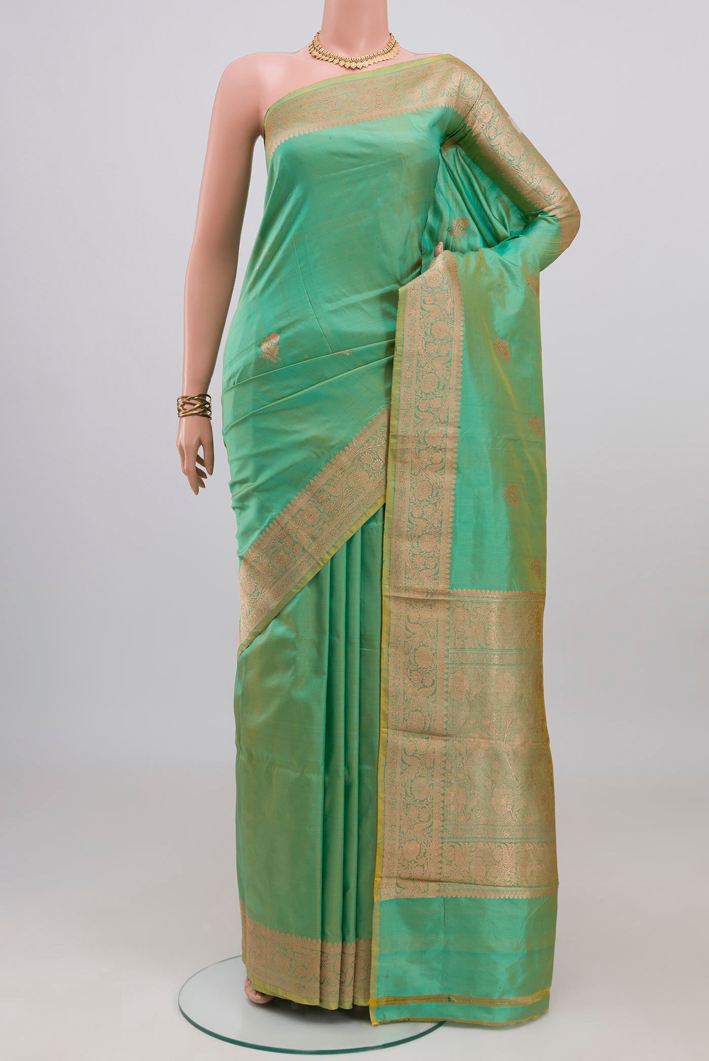 Sea Green Banarasi Katan Silk Saree with Zari Butta on the body and Zari Border.  displayed on a mannequin